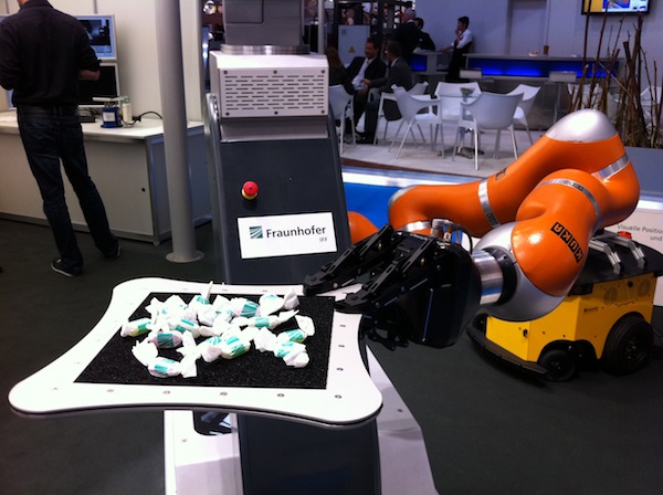 The Fraunhofer IFF lightweight robot offering candies to the crowd at Automatica 2012