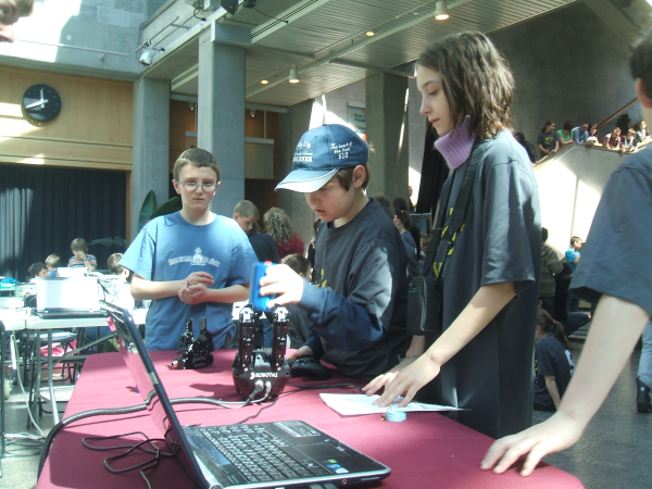 enthusiastic students at ease with robotic controls