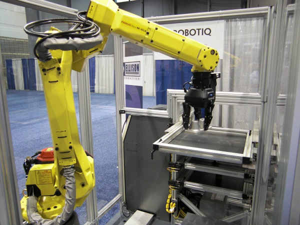 Robotiq 3F gripper mounted on a Fanuc robot arm picking up a part