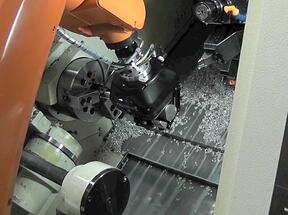 Robotiq 3F gripper loading a part in a CNC lathe