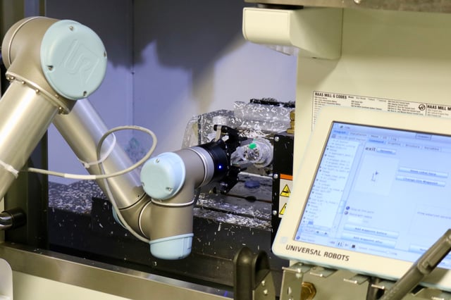 A Robotiq 2F-85 mounted on a UR cobot for machine tending application on a CNC lathe