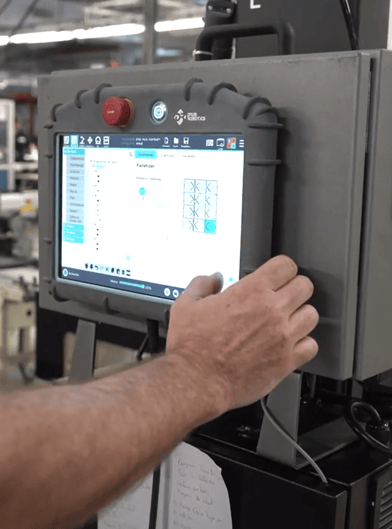 Worker programming the Robotiq Palletizing Solution