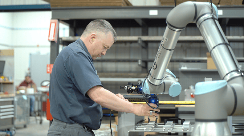 Worker automating machine tending application with a collaborative robot
