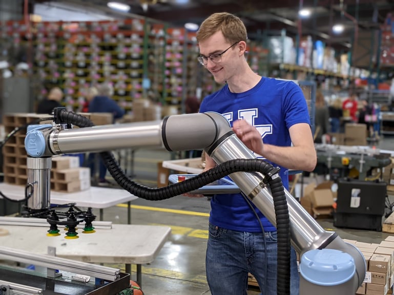 Operator beside a collaborative robot