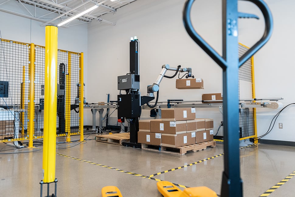 Collaborative robot palletizing and depalletizing cardboard boxes.