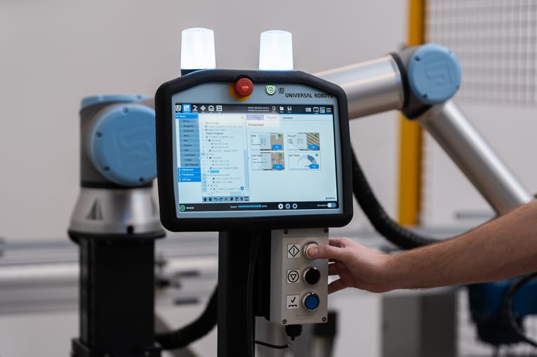 Worker using the Robotiq Palletizing Solution in the pharmaceutical industry.