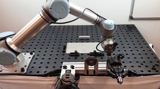 An Universal Robots arm changing its end effector with a tool changer for a Robotiq 2F gripper