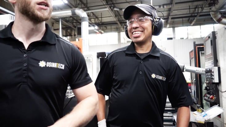 Workers working in a manufacture with a collaborative robot.