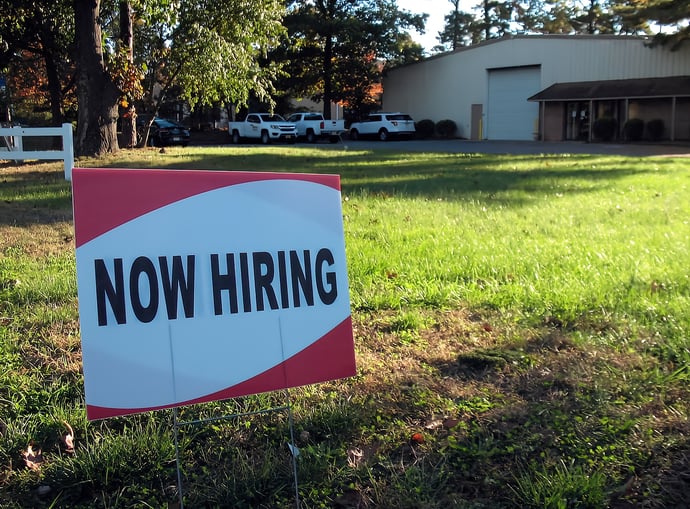 Now hiring sign in front of a manufacture