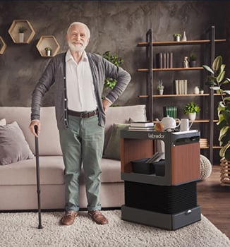 Man standing beside an home robot