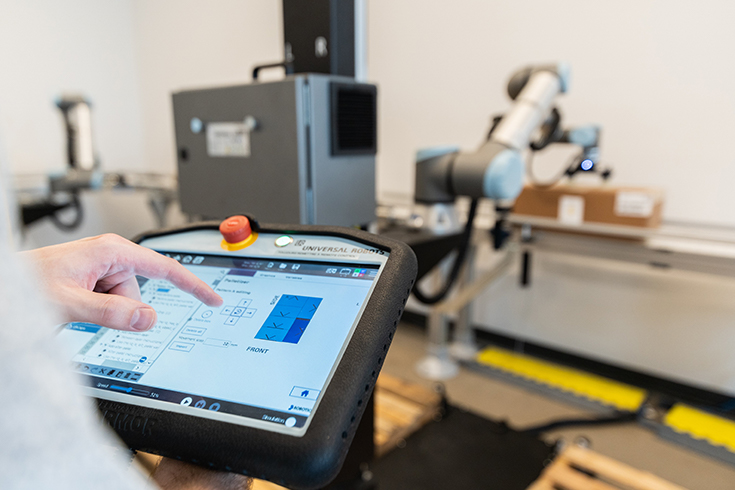 Person programming the Robotiq Palletizing Solution