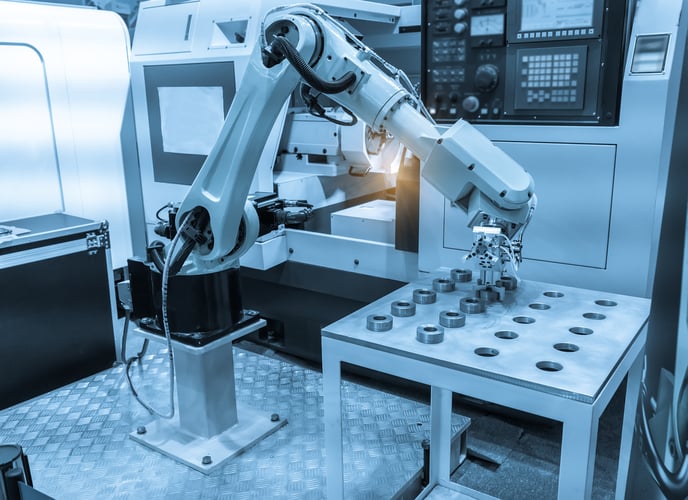 Industrial robot performing a machine tending application