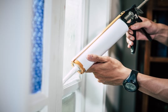 vecteezy_the-carpenter-holds-the-glue-and-attaches-to-the-window_4811911